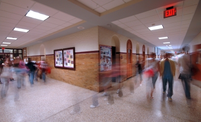 Blurred photo of students walking in a hallway at a school