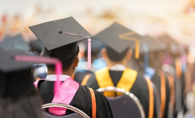 Students wearing caps and gowns at a graduation ceremony