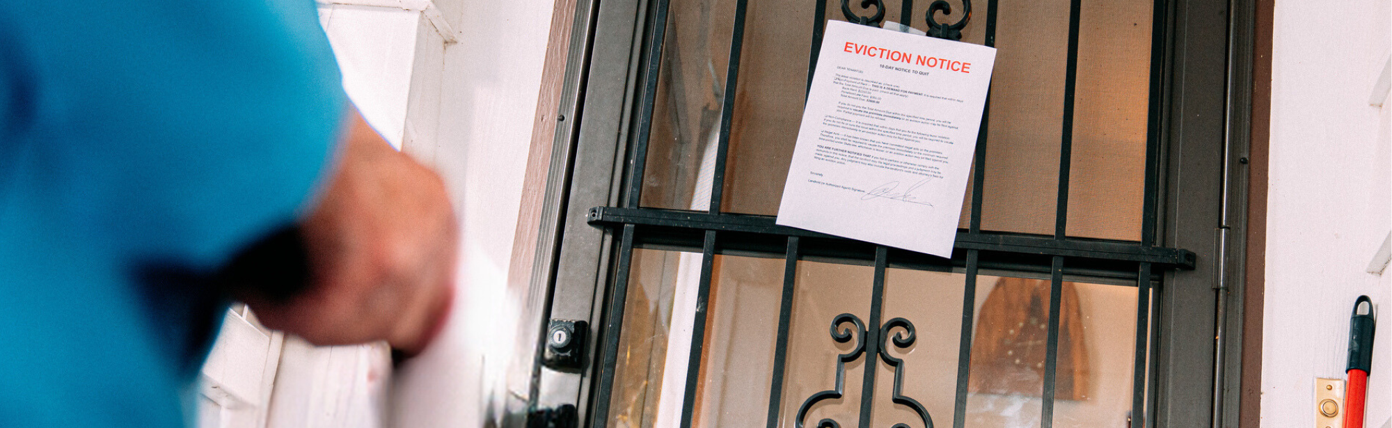 Person approaches their home and sees an eviction notice taped to the door