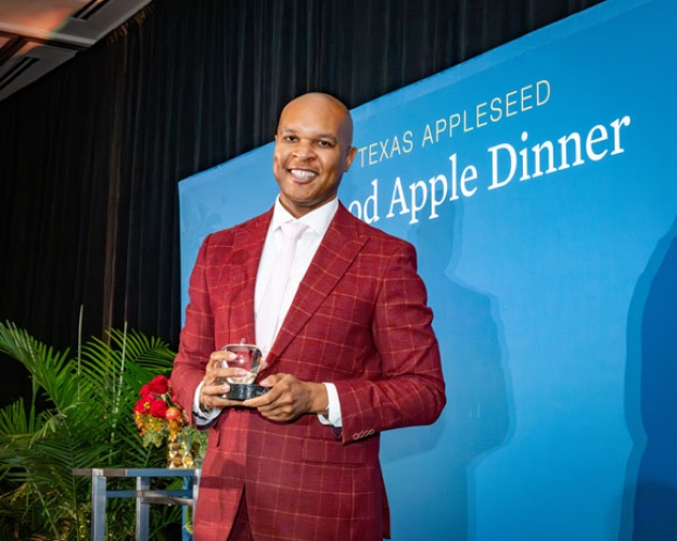 Travis Torrence smiling with the Good Apple Award