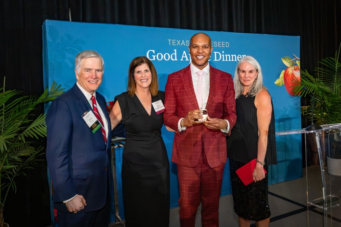Travis Torrence smiling with the Good Apple Award